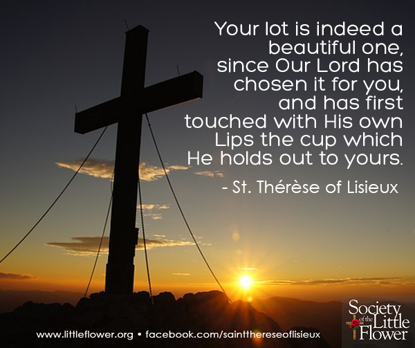 Silhouette of a cross on a hill at sunrise.
