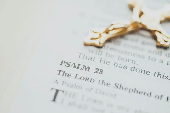 Rosary laying on open bible.