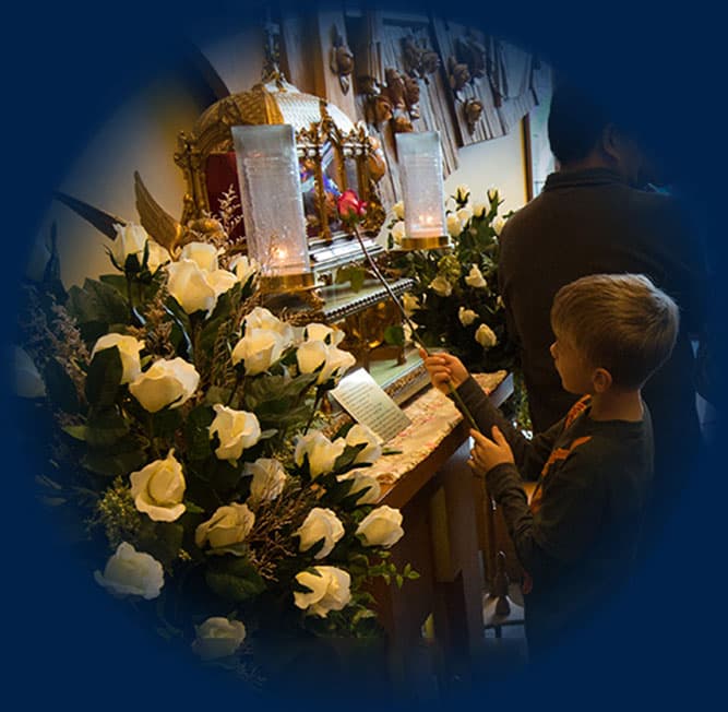 child holding rose celebrating st. therese feast day