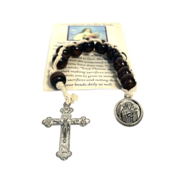 String of brown beads with a silver medal of St Therese on one end and a silver Cross on the other end