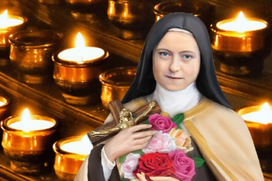 St Therese in front of lit vigil candles