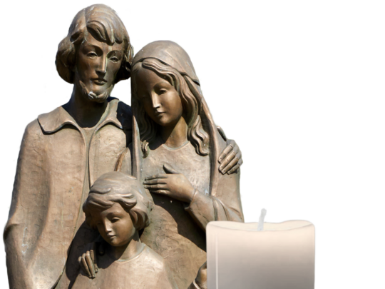 Bronze statue of the Holy Family with a candle