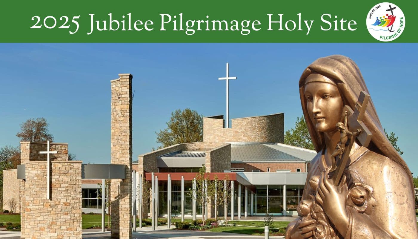 Jubilee Logo and bronze statue of St. Therese with National Shrine in the background