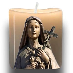St Therese bronze statue image on unlit vigil candle